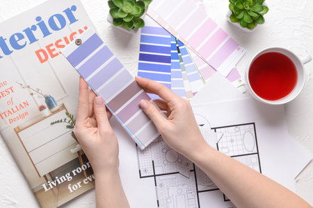 Woman with paint color palettes on white background