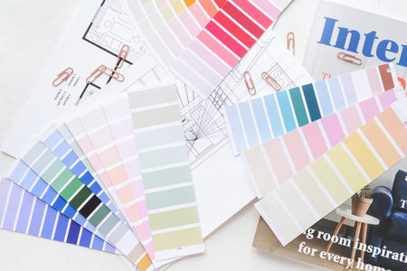 Paint color samples with house plan and magazine on white backgroundの写真素材