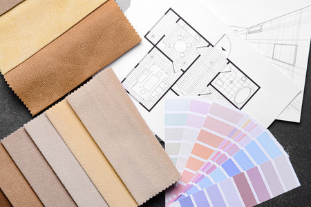 Composition with paint palette colors and fabric samples on dark backgroundの写真素材