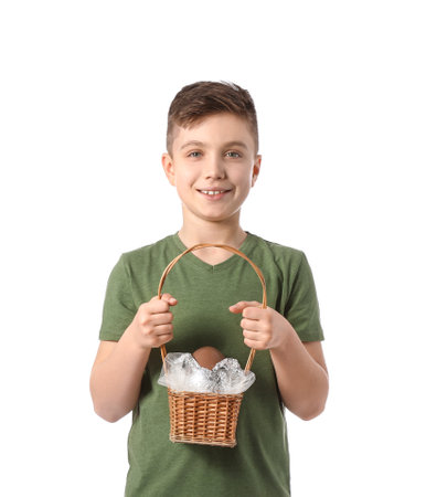 Cute little boy with big chocolate Easter egg in basket on white background