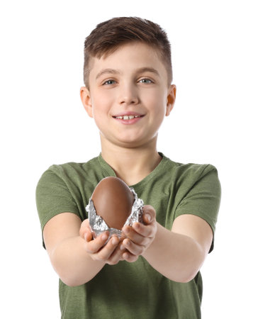 Cute little boy with chocolate Easter egg on white background