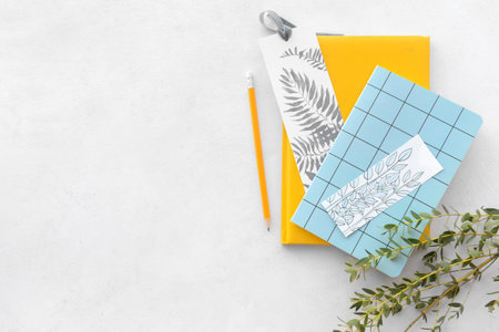 Notebooks with bookmarks and branches on light backgroundの写真素材