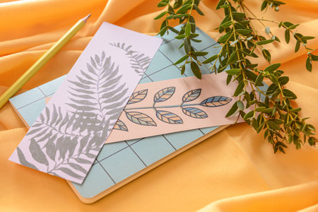 Notebook with bookmarks and branches on color background
