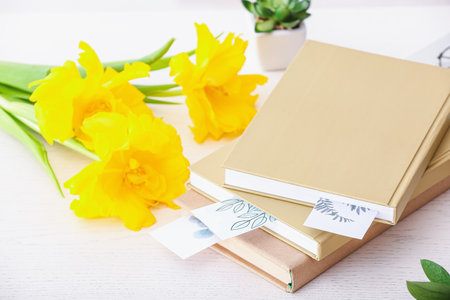 Books and flowers on light backgroundの写真素材