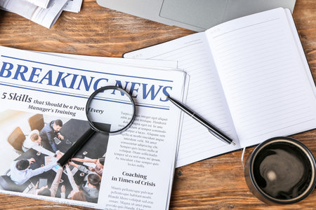 Composition with newspaper and notebook on wooden backgroundの写真素材