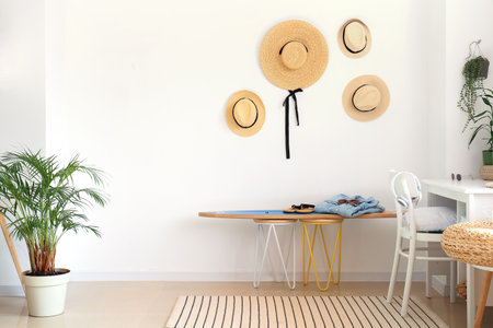Interior of modern stylish room with surfboard, hats and female accessories