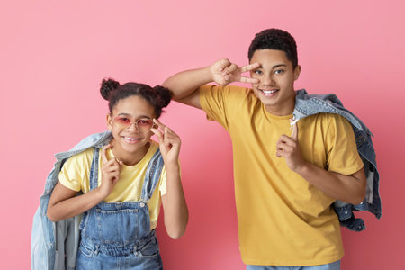 African-American brother and sister on color backgroundの写真素材