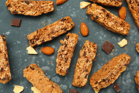 Tasty biscotti cookies, chocolate and almond nuts on gray tableの写真素材