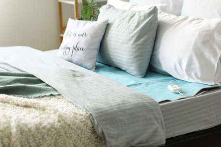 Bed with electric heating pad in bedroom