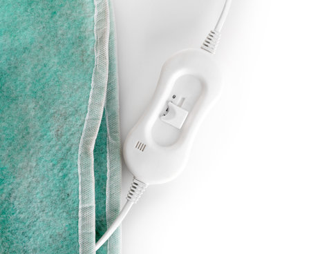 Green electric heating pad with controller on white background, closeupの写真素材