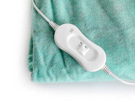Green electric heating pad with controller on white background, closeupの写真素材