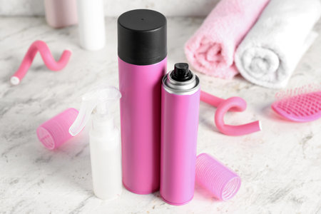Hair sprays with curlers on light table, closeupの写真素材