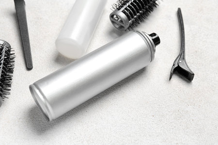 Hair sprays with clips and brushes on light background, closeupの写真素材