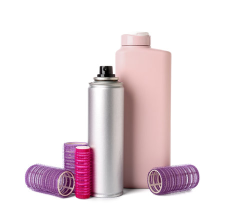 Hair spray bottle of shampoo and curlers on white backgroundの写真素材
