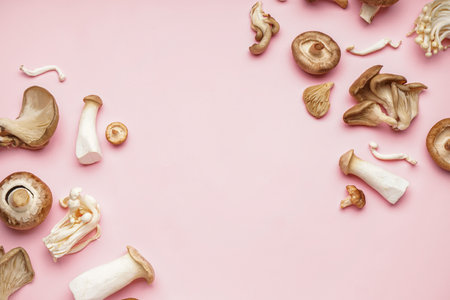 Different fresh mushrooms on pink backgroundの写真素材