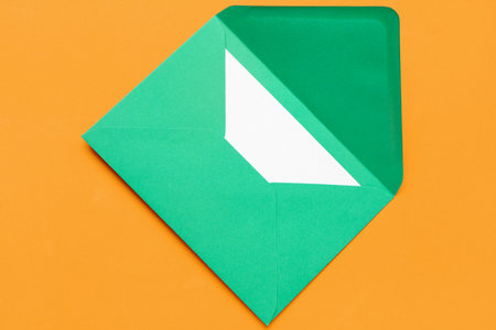 Green envelope with card on color backgroundの写真素材