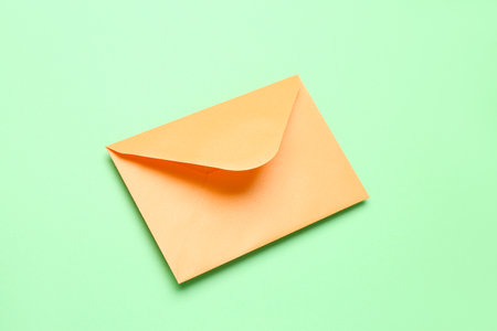 yellow paper envelope on green backgroundの写真素材