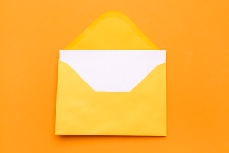yellow envelope with card on color backgroundの写真素材