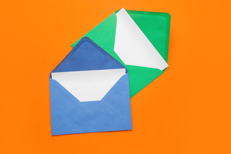 Paper envelopes with cards on orange backgroundの写真素材