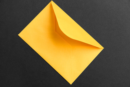 yellow paper envelope on dark background