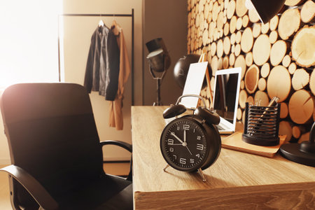 Stylish alarm clock on table in roomの写真素材