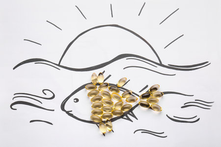 Drawn fish with oil capsules on white backgroundの写真素材