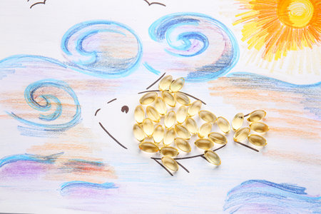 Drawn fish with oil capsules on white backgroundの写真素材