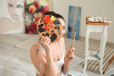 young female artist painting workshopの写真素材