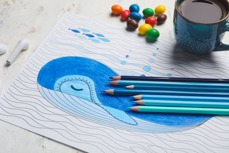 Coloring picture, cup of coffee and pencils on light backgroundの写真素材