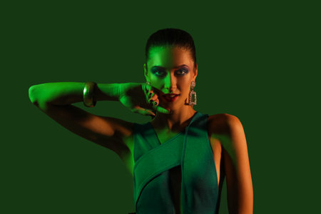 Stylish young woman on dark green backgroundの写真素材