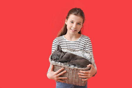 Cute girl with puppy on color backgroundの写真素材
