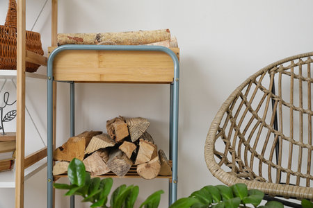 Stand with firewood near light wallの写真素材