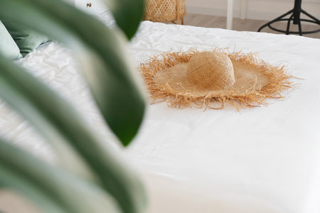 Stylish hat on bed in bedroomの写真素材