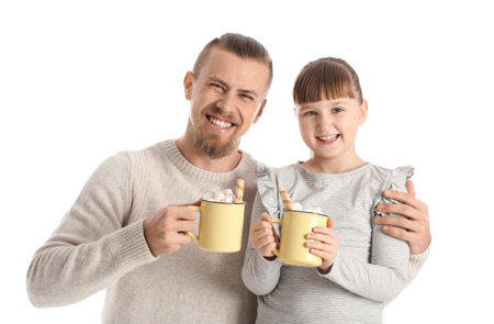 Happy daughter and father with cups of hot cocoa on white backgroundの写真素材