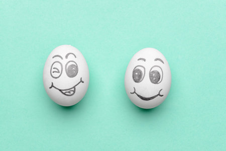 Funny eggs on color background