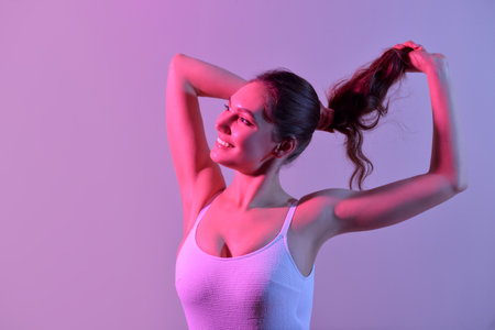 Beautiful young woman in swimsuit on color background