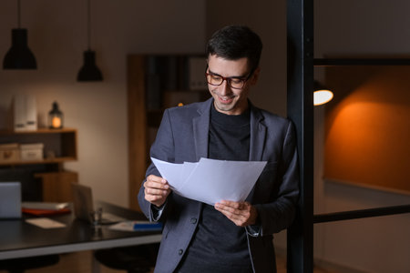 businessman working in office late at nightの写真素材