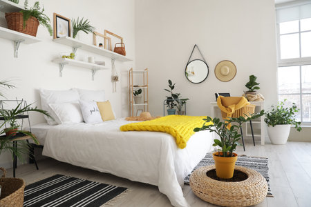 Stylish interior of modern bedroom with houseplants