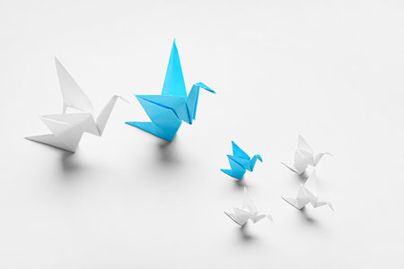 Origami birds on light background. concept of uniquenessの写真素材