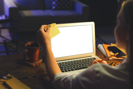 Female freelancer working at home late in the eveningの写真素材