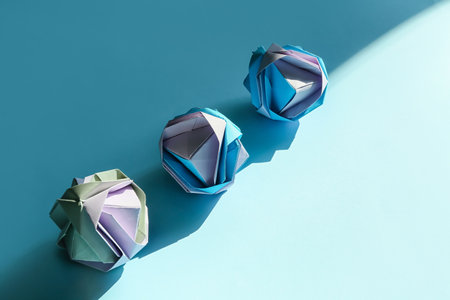 Origami flowers on color background. concept of uniquenessの写真素材