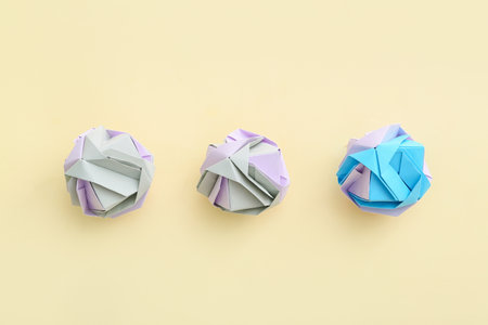Origami flowers on color background. concept of uniquenessの写真素材