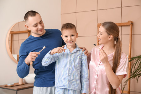 Family brushing teeth in bathroomの写真素材