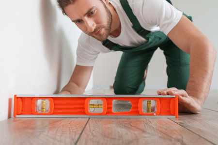 Carpenter taking measurements in roomの写真素材