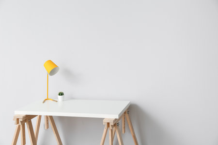 Comfortable workplace near light wall in roomの写真素材