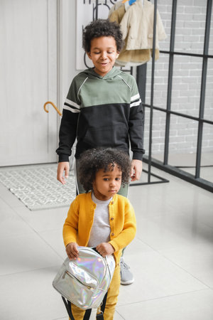 African-American children with backpack at home