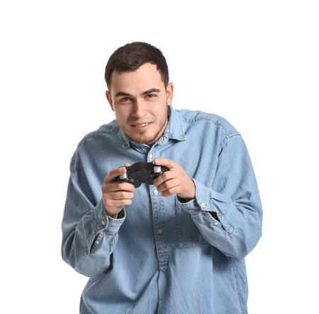Handsome young man playing video game on white background