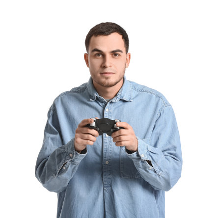 Handsome young man playing video game on white background
