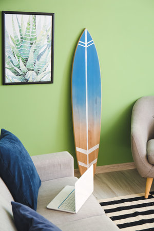 Interior of modern stylish room with armchair, sofa and surfboardの写真素材