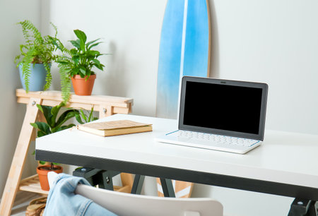 Table with laptop in modern roomの写真素材